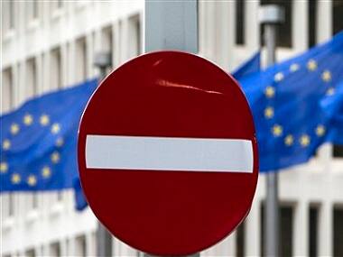 EU flags flutter in the wind in back of a no entry street sign in front of EU headquarters in Brussels on Friday, June 24, 2016. Voters in the United Kingdom voted in a referendum on Thursday to decide whether Britain remains part of the European Union or leaves the 28-nation bloc. Results will be known later on Friday. (AP Photo/Virginia Mayo)