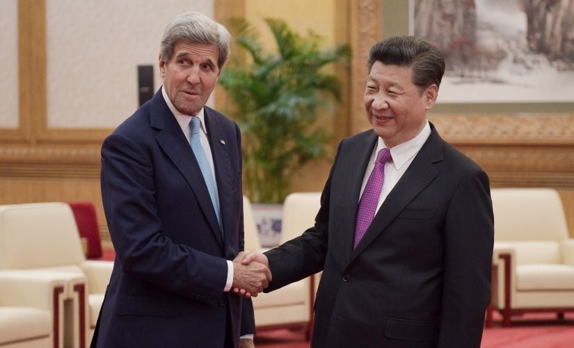 Chinese President Xi Jinping shakes hands with US Secretary of State John Kerry prior to a meeting at the Great Hall of the People in Beijing on Tuesday. AP