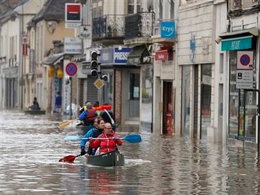 Residents evacuate their home in Nemours, 50 miles south of Paris. AP.