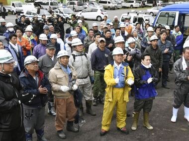 Rescuers of the Japanese boy. AP