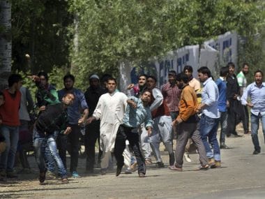 Kashmiri villagers throw stones at Indian security personnel in support of rebels during a gunbattle in Khonshipora. AP