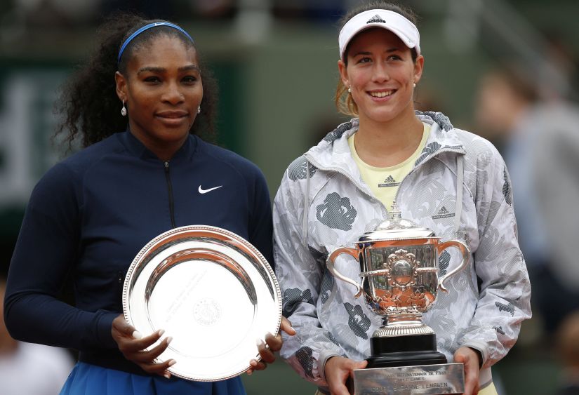 Garbine Muguruza, right, and Serena Williams hold their trophies after the French Open final. AP