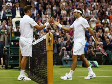 Roger Federer (right) shakes hands with unfancied opponent Marcus Willis at the end of the second-round clash on day three of Wimbledon 2016. Getty Images