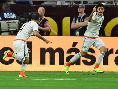 Mexico's Rafael Marquez celebrates with teammates after scoring against Uruguay. AFP