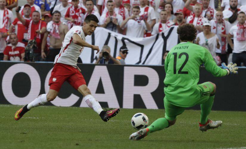 Bartosz Kapustka kicks the ball in front of Ukraine goalkeeper Andriy Pyatov during the Euro 2016 Group C match. AP