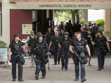 Los Angeles Police officers walk by the Mathematical Sciences Building on the UCLA campus after a fatal shooting at the University of California. AP