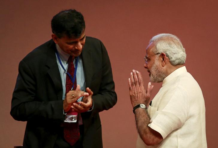 Prime Minister Narendra Modi gestures to Reserve Bank of India (RBI) Governor Raghuram Rajan at an event on financial inclusion in Mumbai April 2, 2015. REUTERS/Danish Siddiqui/File Photo