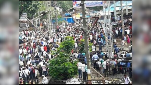 Mumbai's first showers halts train services, commuters block tracks in protest