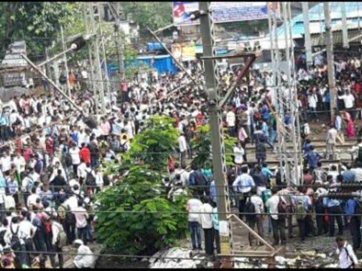Mumbai's first showers halts train services, commuters block tracks in protest