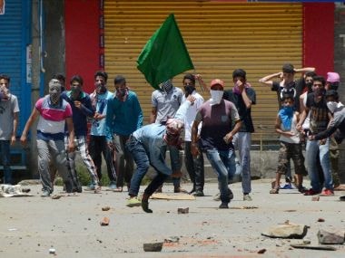 Protesters throw stones at police during a clash that broke out in Bemina, Srinagar on Tuesday. PTI