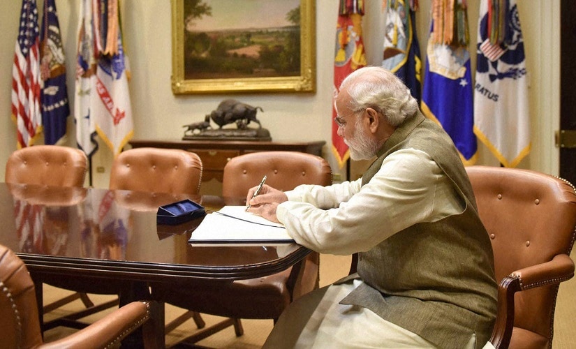 Narendra Modi signing the visitors' book, at White House on Tuesday. PTI