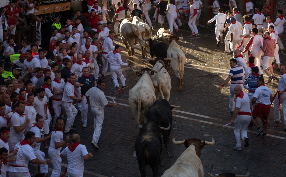 Participants run ahead of Fuente Ymbro fighting bulls on the first day of the San Fermin bull run on 7 July , 2016, in Pamplona, northern Spain. AFP. Participants run ahead of Fuente Ymbro fighting bulls on the first day of the San Fermin bull run on 7 July , 2016, in Pamplona, northern Spain. AFP.