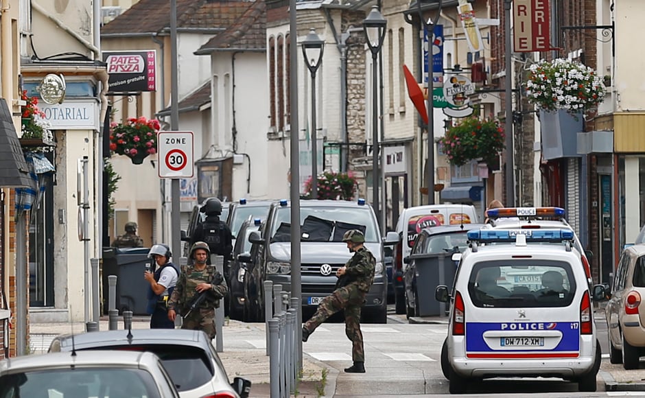 French soldiers stand guard near the scene of an attack in Saint-Etienne-du-Rouvray, Normandy, France, Tuesday, 26 July, 2016. Two attackers invaded a church Tuesday during morning Mass near the Normandy city of Rouen, killing an 84-year-old priest by slitting his throat and taking hostages before being shot and killed by police, French officials said. AP Photo/Francois Mori French soldiers stand guard near the scene of an attack in Saint-Etienne-du-Rouvray, Normandy, France, Tuesday, 26 July, 2016. Two attackers invaded a church Tuesday during morning Mass near the Normandy city of Rouen, killing an 84-year-old priest by slitting his throat and taking hostages before being shot and killed by police, French officials said. AP Photo/Francois Mori