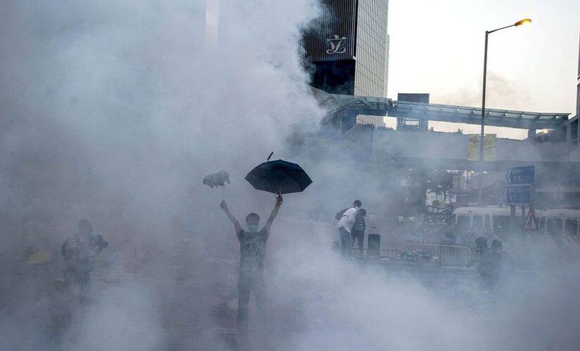 A pro-democracy protester stood strong as police fired tear gas Hong Kong government headquarters. Getty