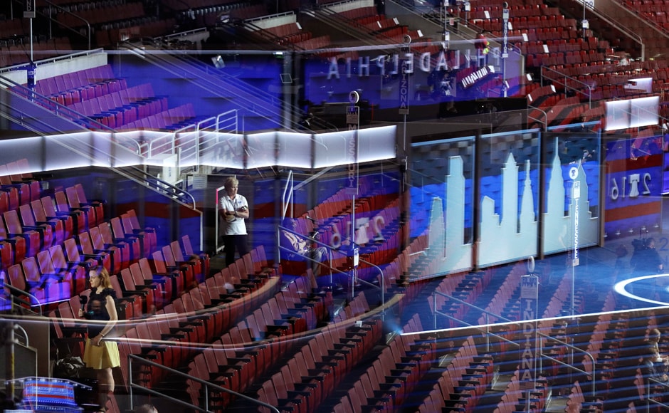 Seen through a reflection of the stage in a window, people stand in the seats during preparations for the DNC. The party announced Monday it would kick off its four-day spectacle with speeches from some of its most popular figures. Massachusetts Sen. Elizabeth Warren, a progressive favourite, would deliver the convention keynote. Sanders and First Lady Michelle Obama will also take the stage. AP Seen through a reflection of the stage in a window, people stand in the seats during preparations for the DNC. The party announced Monday it would kick off its four-day spectacle with speeches from some of its most popular figures. Massachusetts Sen. Elizabeth Warren, a progressive favourite, would deliver the convention keynote. Sanders and First Lady Michelle Obama will also take the stage. AP