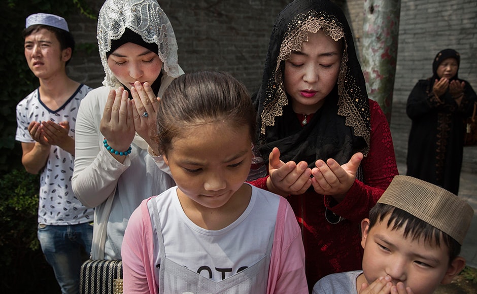 A Chinese Hui Muslim family prays at the 'Sheiks Tombs'. China's constitution provides for Islam as one of five 'approved' religions in the officially atheist country though the government enforces severe limits. Worship is permitted only at state-sanctioned mosques and proselytizing in public is illegal. Getty images. A Chinese Hui Muslim family prays at the 'Sheiks Tombs'. China's constitution provides for Islam as one of five 'approved' religions in the officially atheist country though the government enforces severe limits. Worship is permitted only at state-sanctioned mosques and proselytizing in public is illegal. Getty images.