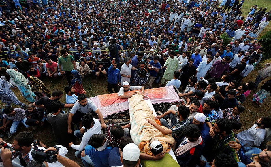 More than 20,000 people, who came from different parts of Pulwama district, gathered at Shariefabad (Tral) to attend the burial by defying curfew restrictions imposed by the authorities. Shouting pro-Islam and pro-Azadi slogans, mourners at the burial appeared surcharged as youths raised slogans vowing to follow Wani's path. The authorities withdrew all security forces deployed around the ground to prevent clashes with the agitated people. Reuters More than 20,000 people, who came from different parts of Pulwama district, gathered at Shariefabad (Tral) to attend the burial by defying curfew restrictions imposed by the authorities. Shouting pro-Islam and pro-Azadi slogans, mourners at the burial appeared surcharged as youths raised slogans vowing to follow Wani's path. The authorities withdrew all security forces deployed around the ground to prevent clashes with the agitated people. Reuters
