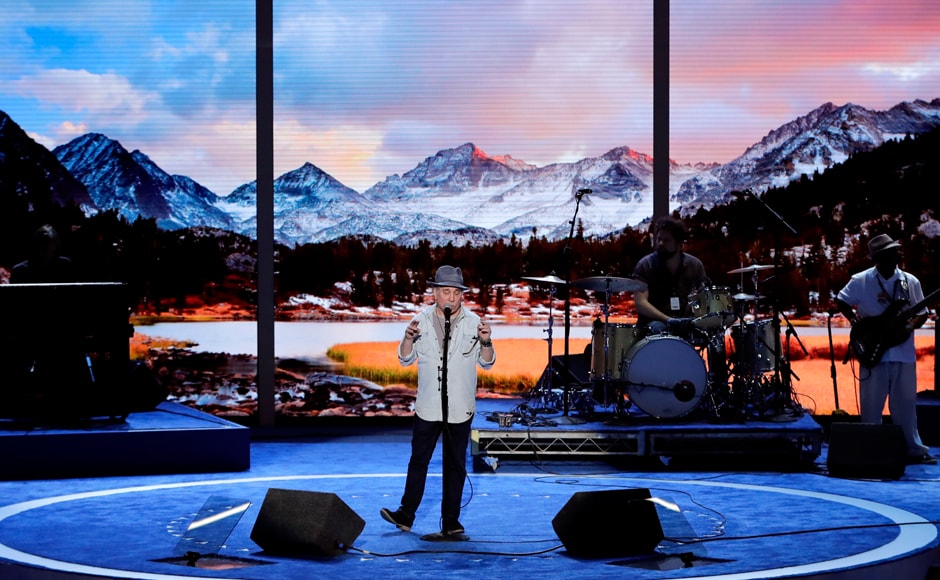Singer/songwriter Paul Simon rehearses at the Wells Fargo Center. The 74-year-old American has won 12 Grammy Awards and was part of the duo Simon & Garfunkel. AP Singer/songwriter Paul Simon rehearses at the Wells Fargo Center. The 74-year-old American has won 12 Grammy Awards and was part of the duo Simon & Garfunkel. AP