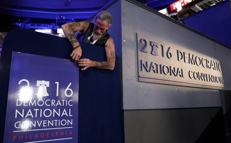 Gary Gort, a set carpenter with CNN, adjusts a sign during preparations before the 2016 Democratic Convention on Sunday in Philadelphia. The DNC begins on Monday at the Wells Fargo Center. AP Gary Gort, a set carpenter with CNN, adjusts a sign during preparations before the 2016 Democratic Convention on Sunday in Philadelphia. The DNC begins on Monday at the Wells Fargo Center. AP