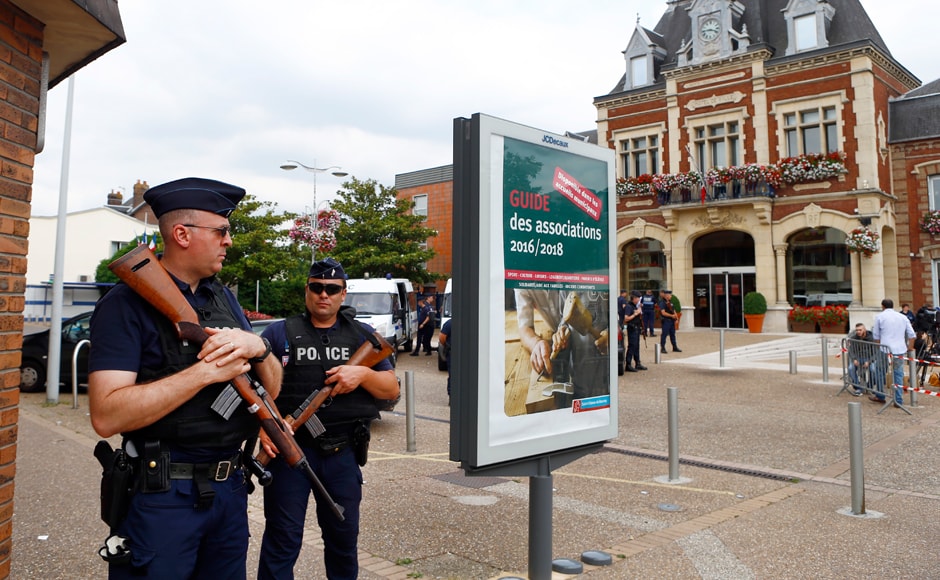 French police officers stand guard in front of the Saint-Etienne-du-Rouvray's city hall, Normandy, France, after an attack on a church that left a priest dead, Tuesday, 26 July, 2016. Two attackers invaded a church Tuesday during morning Mass near the Normandy city of Rouen, killing an 84-year-old priest by slitting his throat and taking hostages before being shot and killed by police, French officials said. AP /Francois Mori French police officers stand guard in front of the Saint-Etienne-du-Rouvray's city hall, Normandy, France, after an attack on a church that left a priest dead, Tuesday, 26 July, 2016. Two attackers invaded a church Tuesday during morning Mass near the Normandy city of Rouen, killing an 84-year-old priest by slitting his throat and taking hostages before being shot and killed by police, French officials said. AP /Francois Mori