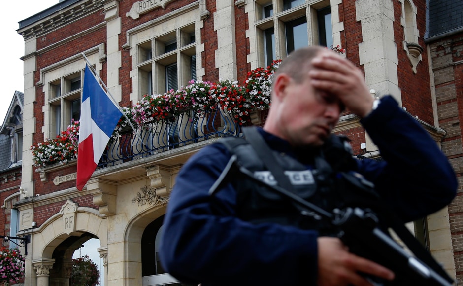 A policeman reacts as he secures a position in front of the city hall after two assailants had taken five people hostage in the church at Saint-Etienne-du -Rouvray near Rouen in Normandy, France, 26 July, 2016. Two attackers killed a priest with a blade and seriously wounded another hostage in a church in northern France on Tuesday before being shot dead by French police. Reuters/Pascal Rossignol A policeman reacts as he secures a position in front of the city hall after two assailants had taken five people hostage in the church at Saint-Etienne-du -Rouvray near Rouen in Normandy, France, 26 July, 2016. Two attackers killed a priest with a blade and seriously wounded another hostage in a church in northern France on Tuesday before being shot dead by French police. Reuters/Pascal Rossignol