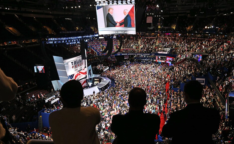 People watch a television monitor from the upper seats as Donald Trump shakes hands with Mike Pence at the Republican National Convention in Cleveland, Ohio. Trump had earlier announced that Pence would be his running mate as the race for the US Presidential election 2016 heats up in earnest. Reuters People watch a television monitor from the upper seats as Donald Trump shakes hands with Mike Pence at the Republican National Convention in Cleveland, Ohio. Trump had earlier announced that Pence would be his running mate as the race for the US Presidential election 2016 heats up in earnest. Reuters