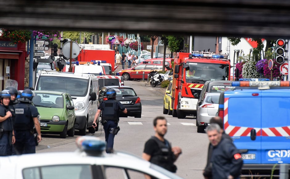 Police and rescue workers stand at the scene after two assailants had taken five people hostage in the church at Saint-Etienne-du -Rouvray near Rouen in Normandy, France, 26 July, 2016. Two attackers killed a priest with a blade and seriously wounded another hostage in a church in northern France on Tuesday before being shot dead by French police. Reuters/Steve Bonet Police and rescue workers stand at the scene after two assailants had taken five people hostage in the church at Saint-Etienne-du -Rouvray near Rouen in Normandy, France, 26 July, 2016. Two attackers killed a priest with a blade and seriously wounded another hostage in a church in northern France on Tuesday before being shot dead by French police. Reuters/Steve Bonet