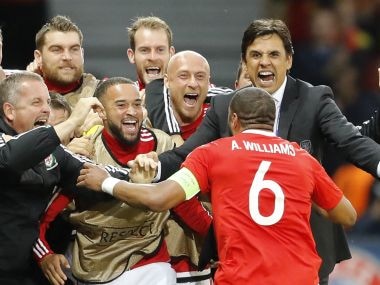 Wales coach Chris Coleman and Ashley Williams celebrate the centre-back's goals. AP