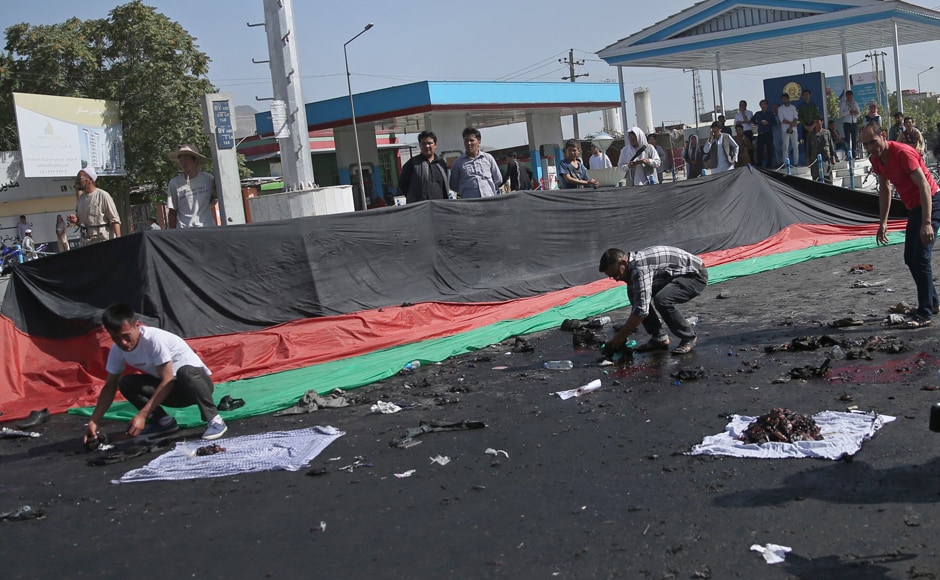 Afghans gather property, left behind by victims of a deadly explosion that struck a protest march by ethnic Hazaras, in Kabul, Afghanistan, Saturday, July 23, 2016. The protesters on Saturday were demanding that a major regional electric power line be routed through their impoverished home province. AP Afghans gather property, left behind by victims of a deadly explosion that struck a protest march by ethnic Hazaras, in Kabul, Afghanistan, Saturday, July 23, 2016. The protesters on Saturday were demanding that a major regional electric power line be routed through their impoverished home province. AP