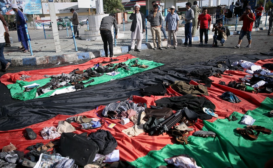 Afghans look at property left behind by victims of an explosion that struck a protest march, that is displayed on a large representation of the Afghan flag, in Kabul, Afghanistan, Saturday, 23 July, 2016. AP Afghans look at property left behind by victims of an explosion that struck a protest march, that is displayed on a large representation of the Afghan flag, in Kabul, Afghanistan, Saturday, 23 July, 2016. AP