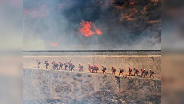One body found, thousands evacuated, as wildfires continue to rage through California
