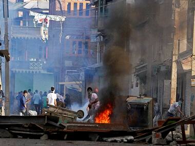 Srinagar: Youths throwing stones at security forces after blocking a road during clashes in Srinagar on Monday. PTI Photo by S Irfan (PTI7_18_2016_000267B)