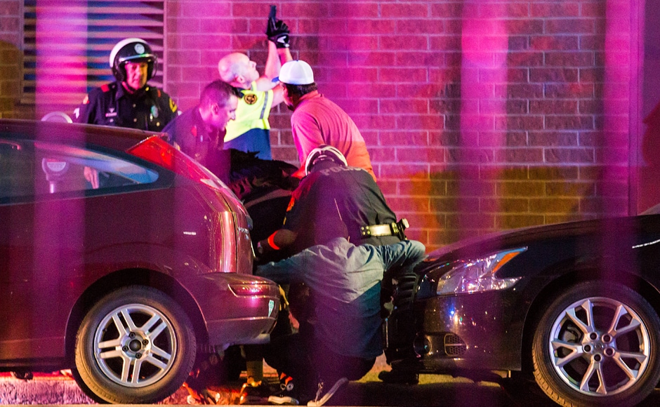 Scores of police and security officers were on hand. Police and others hunched behind cars outside a parking garage. Officers with guns drawn were running near and into the parking garage as police searched for the shooter. AP Scores of police and security officers were on hand. Police and others hunched behind cars outside a parking garage. Officers with guns drawn were running near and into the parking garage as police searched for the shooter. AP