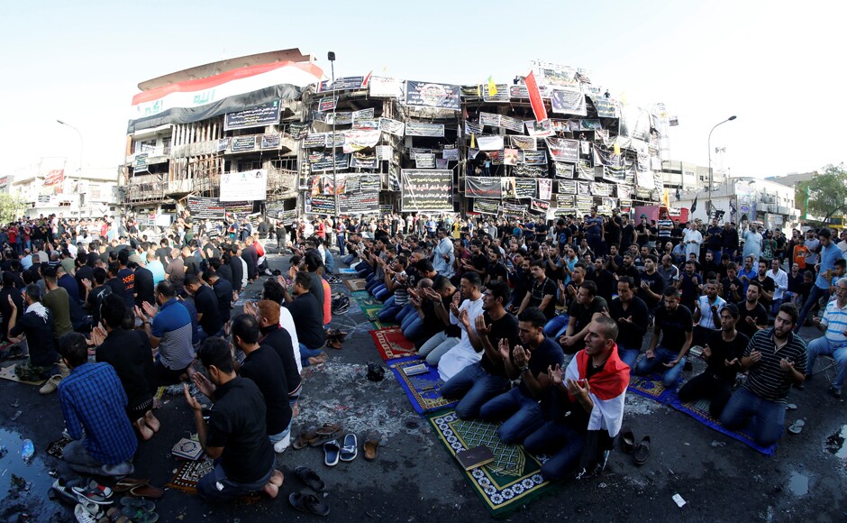 Sunni and Shi'ite Muslims attend prayers during Eid al-Fitr as they mark the end of the fasting month of Ramadan, at the site of a suicide car bomb attack over the weekend at the shopping area of Karrada, in Baghdad, Iraq. Reuters Sunni and Shi'ite Muslims attend prayers during Eid al-Fitr as they mark the end of the fasting month of Ramadan, at the site of a suicide car bomb attack over the weekend at the shopping area of Karrada, in Baghdad, Iraq. Reuters