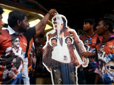 Fans pour milk on a cutout of actor Rajinikanth outside a temple on the eve of the release of Kabali. AP