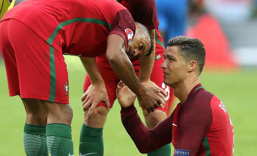 Portugal's Cristiano Ronaldo looked inconsolable as he passes on the captain's armband to Nani. AP