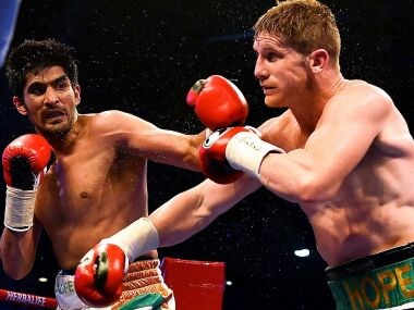 Vijender Singh in action against Kerry Hope. PTI