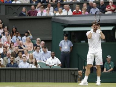 Switzerland's Stan Wawrinka jokes about needing glasses during his match against Del Potro at the Wimbledon. AFP