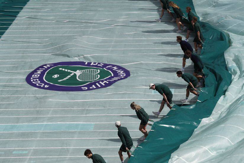 Britain Tennis - Wimbledon - All England Lawn Tennis & Croquet Club, Wimbledon, England - 2/7/16 General view as the cover is pulled over court 1 as rain delays play REUTERS/Stefan Wermuth - RTX2JDPP