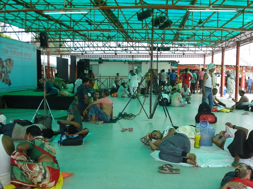 With halls packed to capacity, devotees are forces to seek shelter in a shed. Ambika Choudhary Mahajan
