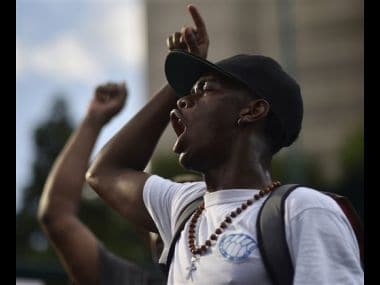 Demonstrators march through downtown Atlanta to protest the shootings of two black men by police officers on Friday. AP