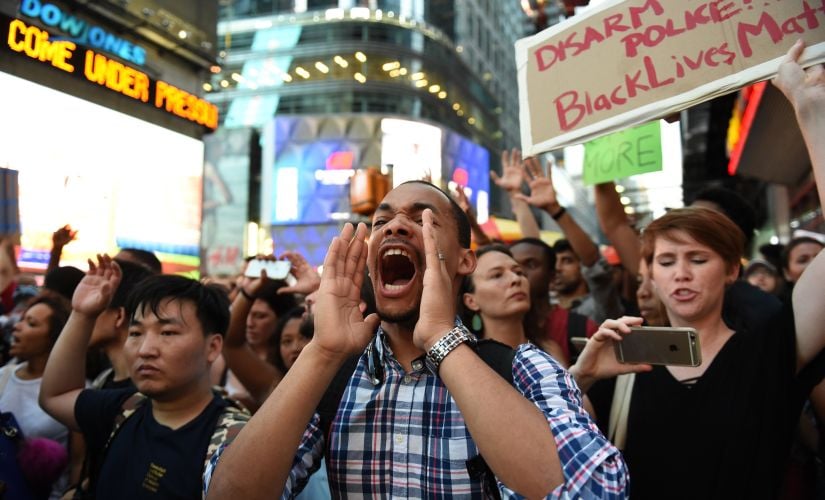 Protesters shout slogans in New York City against the shooting of two black men on Thursday. AFP