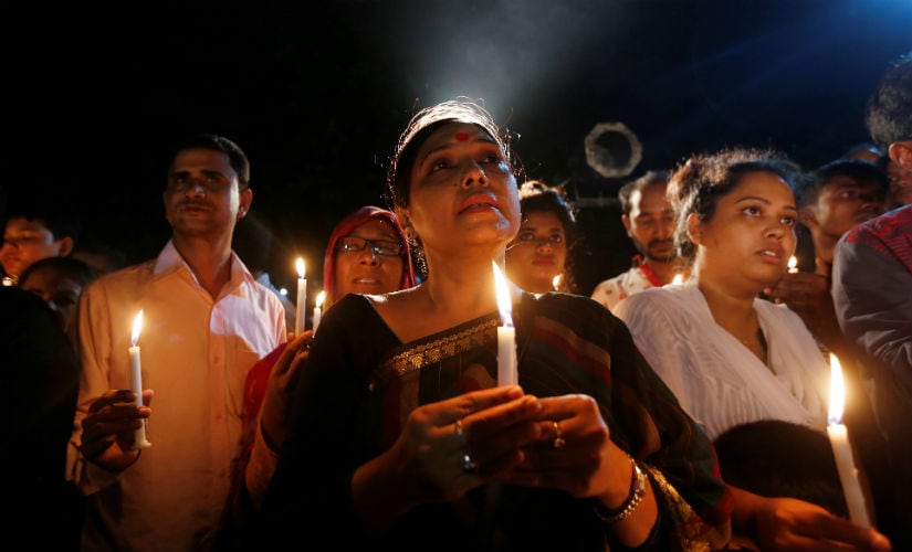 People attend a candle light vigil for the victims of the attack. Reuters