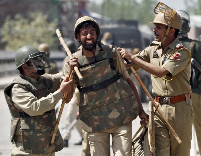 A file image of a police personnel injured during clashes with mob in Srinagar. Reuters