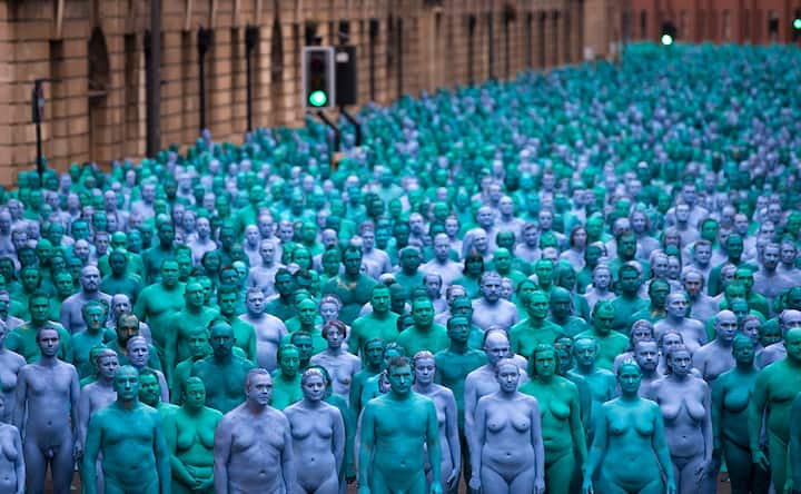Naked volunteers, painted in blue participate in, Spencer Tunick's "Sea of Hull" installation