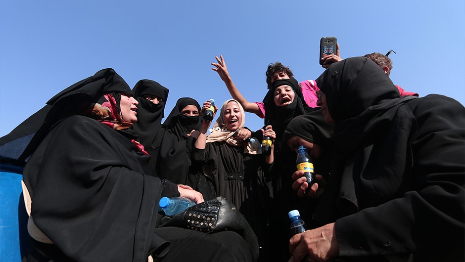 Kurdish television showed footage of jubilant civilians in Manbij, including smiling mothers who had shed their veils, and women embracing Kurdish fighters. One woman burned a black robe that the jihadists had forced residents to wear. Reuters Kurdish television showed footage of jubilant civilians in Manbij, including smiling mothers who had shed their veils, and women embracing Kurdish fighters. One woman burned a black robe that the jihadists had forced residents to wear. Reuters