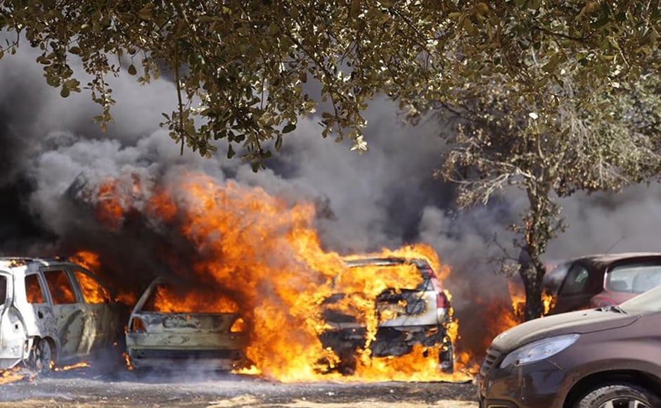Cars burn in a parking lot in Barragem da Povoa in eastern Portugal on Wednesday. Authorities said there were no casualties in the blaze which forced the evacuation of some 4,000 people at the festival. AP Cars burn in a parking lot in Barragem da Povoa in eastern Portugal on Wednesday. Authorities said there were no casualties in the blaze which forced the evacuation of some 4,000 people at the festival. AP