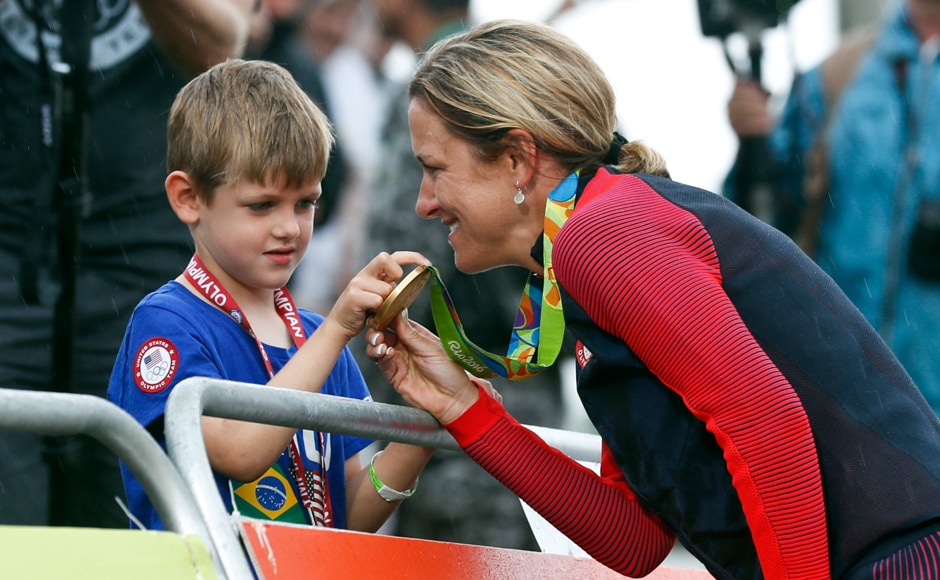 Armstrong shows her gold medal to her son Lucas William Savola. When the 5-year-old approached her at the finish, he asked, Armstrong shows her gold medal to her son Lucas William Savola. When the 5-year-old approached her at the finish, he asked,