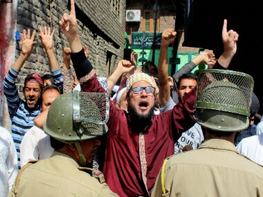 A security jawan stops a motorcylist during 42nd day of curfew and strike in Srinagar on Friday. PTI