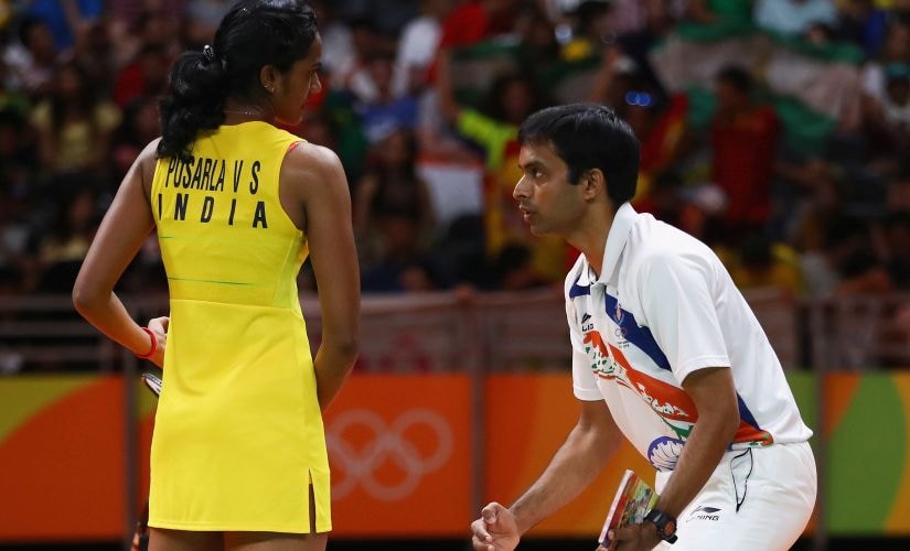 Sindhu deep in conversation with coach Pullela Gopichand at the end of game 2. Getty